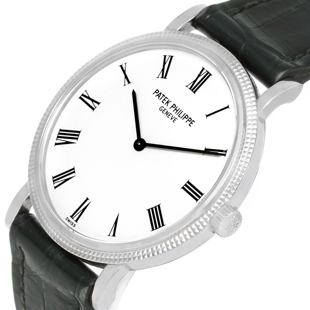The Patek Philippe Calatrava 5120G Men's White Gold White Dial 5120G Men's White Gold White Dial watch is shown at a slight angle, displaying its white dial with black Roman numerals and black leather strap.
