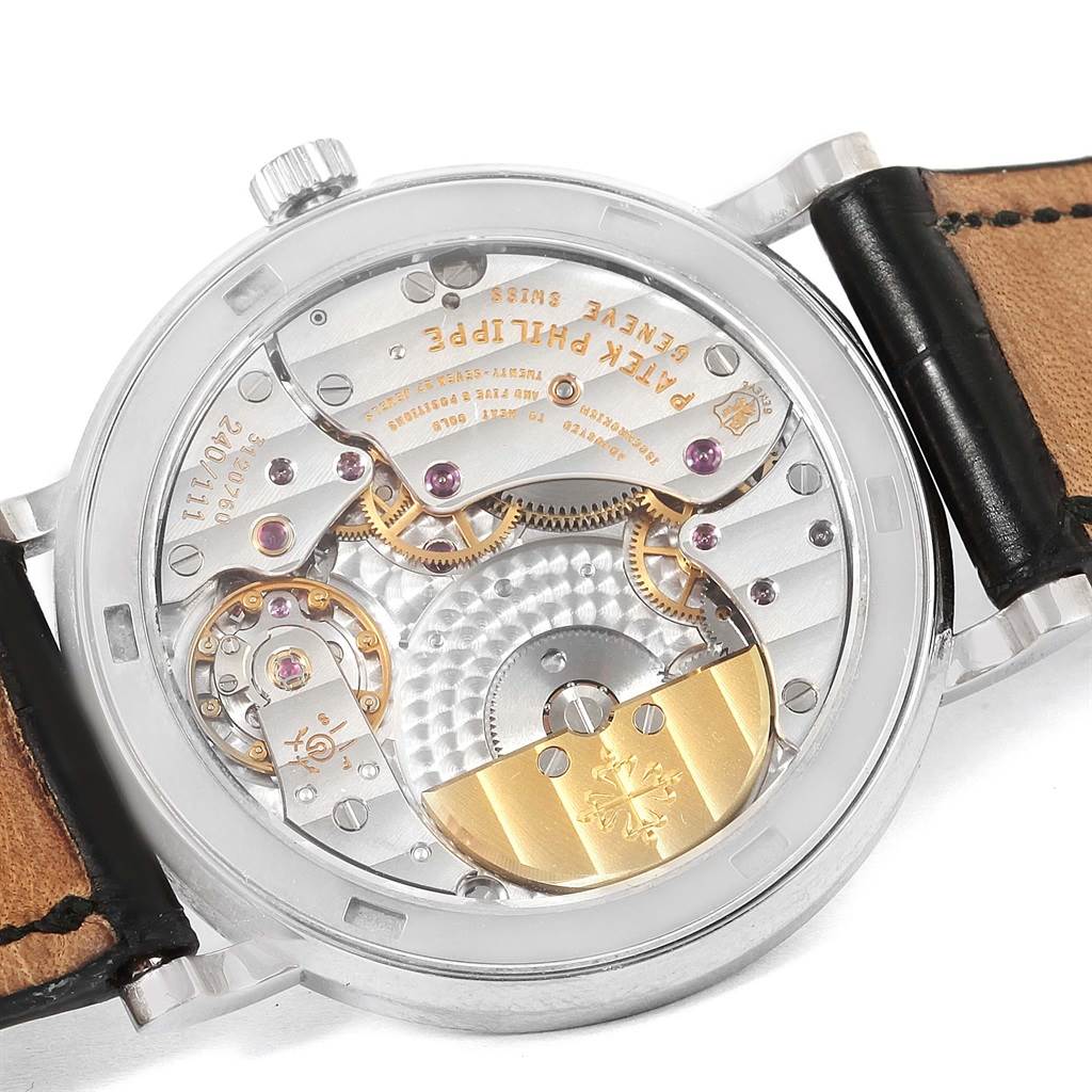 The image shows the back view of a Patek Philippe Calatrava 5120G Men's White Gold White Dial 5120G Men's White Gold White Dial watch, revealing its intricate movement and inner mechanisms.