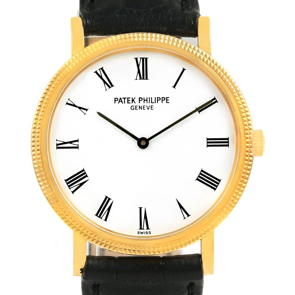 This image shows a front view of a Patek Philippe Calatrava 5120J Men's Yellow Gold White Dial 5120J Men's Yellow Gold White Dial watch, highlighting its dial, bezel, and part of its black leather strap.