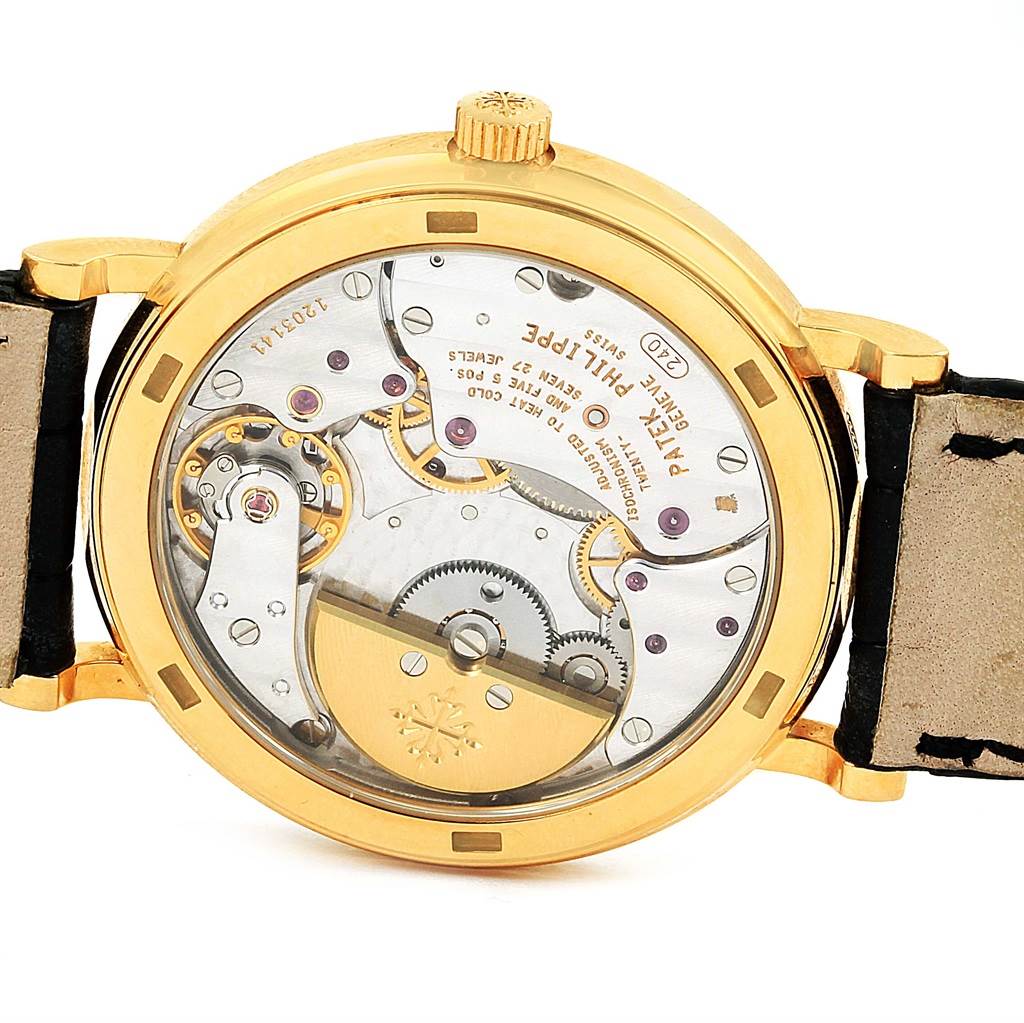 This image shows the back view of the Patek Philippe Calatrava 5120J Men's Yellow Gold White Dial 5120J Men's Yellow Gold White Dial watch, revealing its intricate mechanical movement.