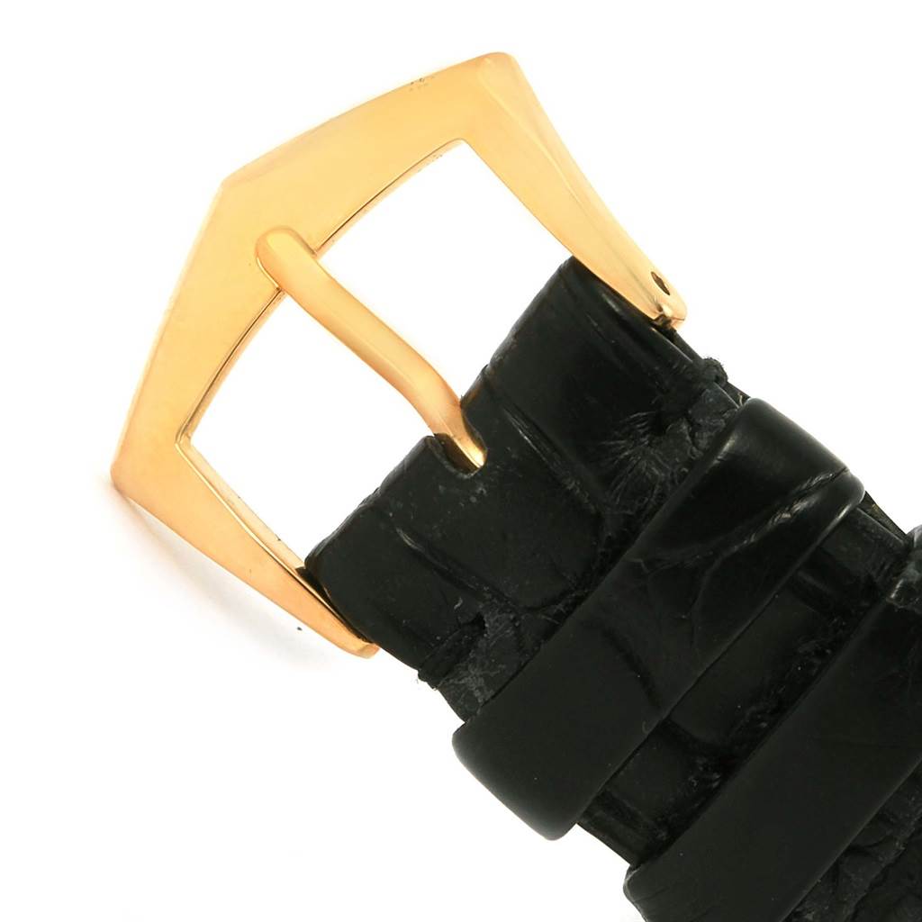 This image shows a close-up of the black leather strap with a gold buckle of a Patek Philippe Calatrava 5120J Men's Yellow Gold White Dial 5120J Men's Yellow Gold White Dial watch.