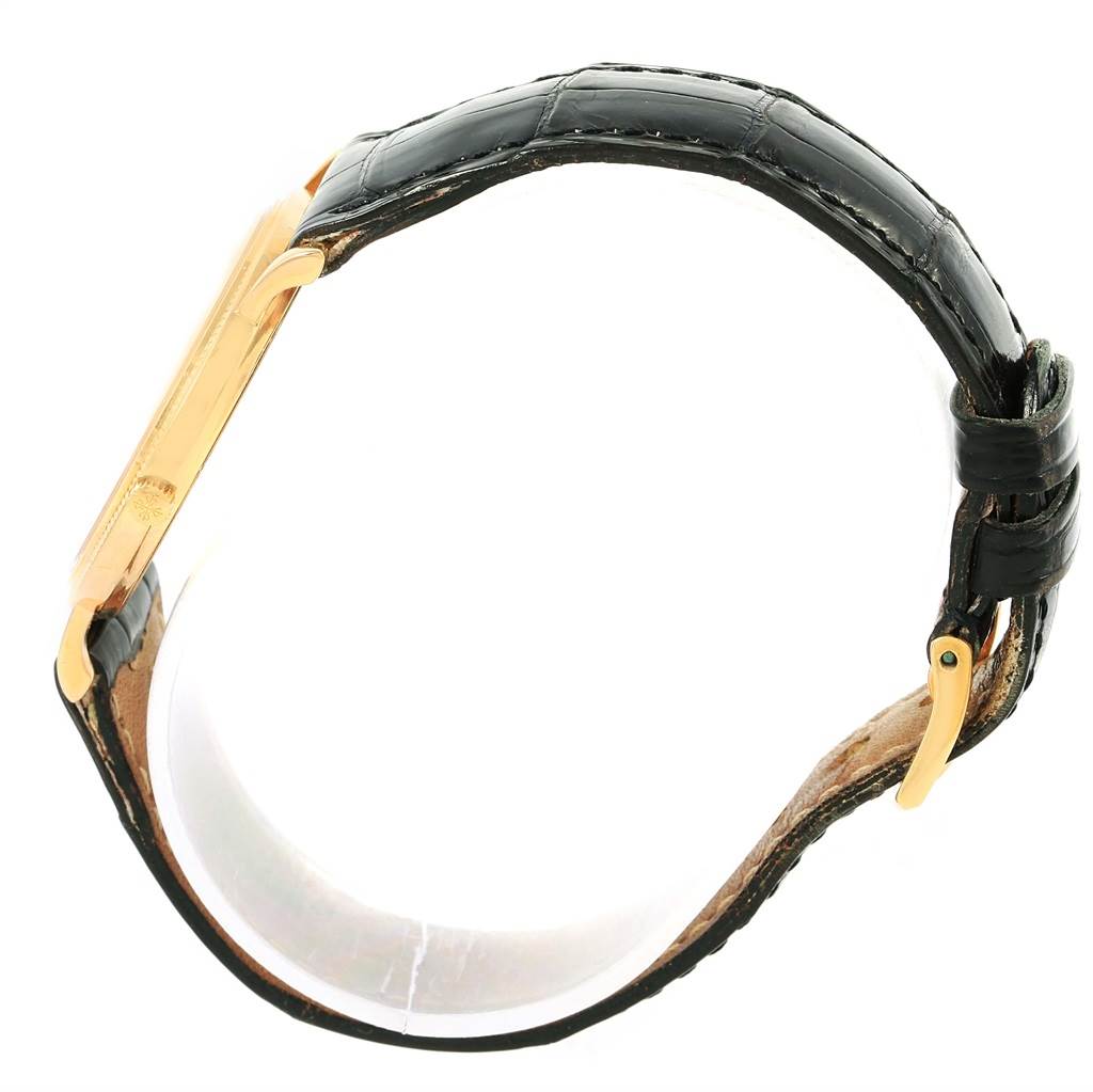 The image shows a side view of the Patek Philippe Calatrava 3520 Men's Yellow Gold White Dial 3520 Men's Yellow Gold White Dial watch, highlighting its strap, case, and buckle.