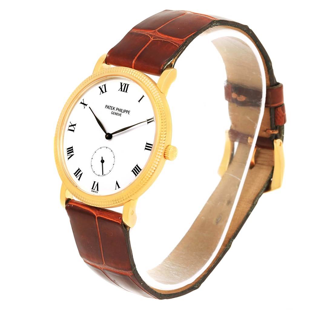 The image shows a Calatrava model by Patek Philippe at a slight angle, highlighting the dial, case, crown, and leather strap.