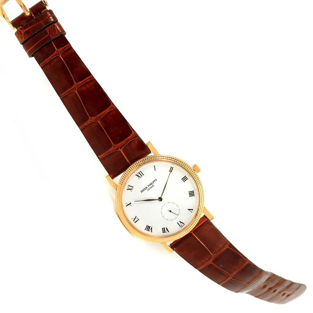 This image shows a top-down view of the Patek Philippe Calatrava 3919 Men's Yellow Gold White Dial 3919 Men's Yellow Gold White Dial watch, featuring the dial, case, and leather strap.