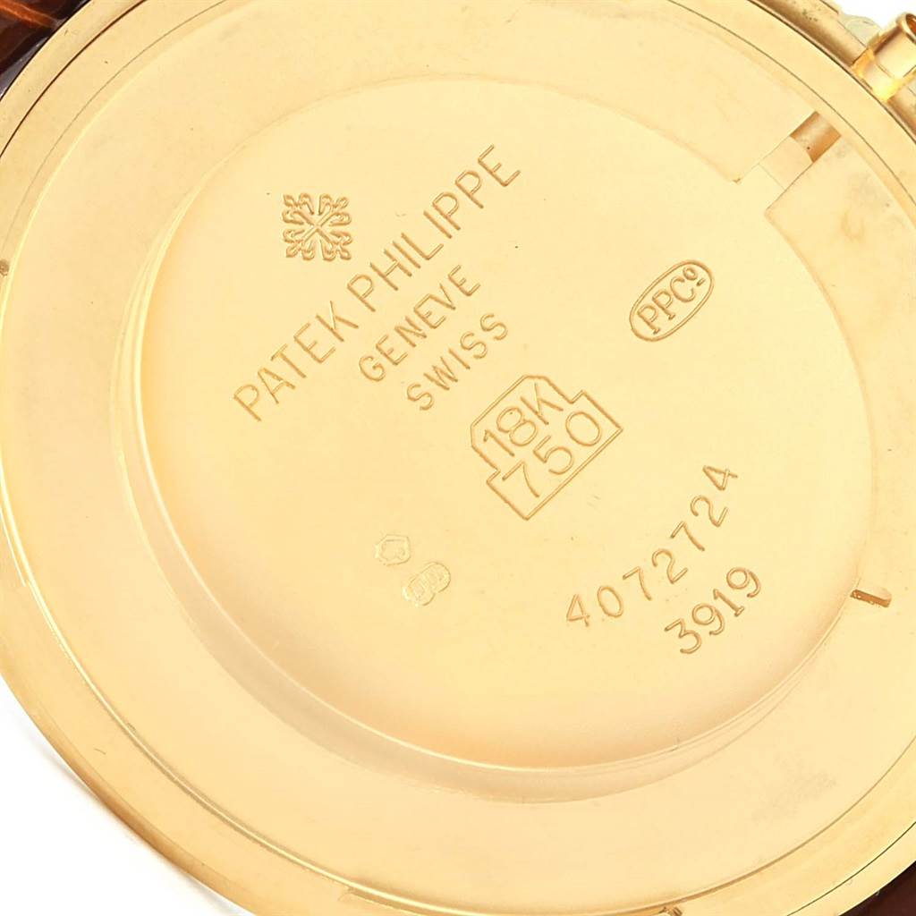 This image shows the back case of a Patek Philippe Calatrava 3919 Men's Yellow Gold White Dial 3919 Men's Yellow Gold White Dial watch, highlighting its markings and gold content.