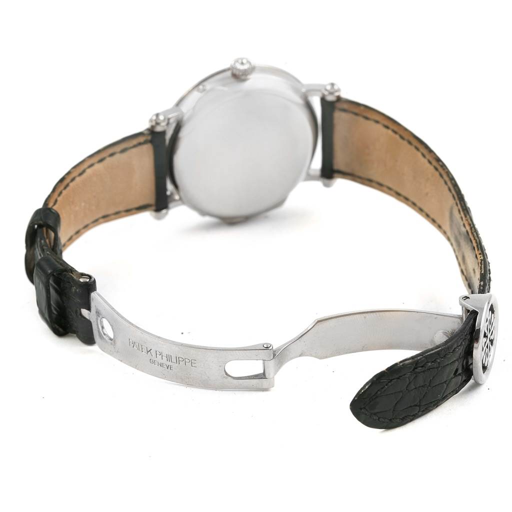 The image shows the back view of the Patek Philippe Complications 5054 Men's White Gold White Dial 5054 Men's White Gold White Dial model, focusing on its leather strap and metal clasp.