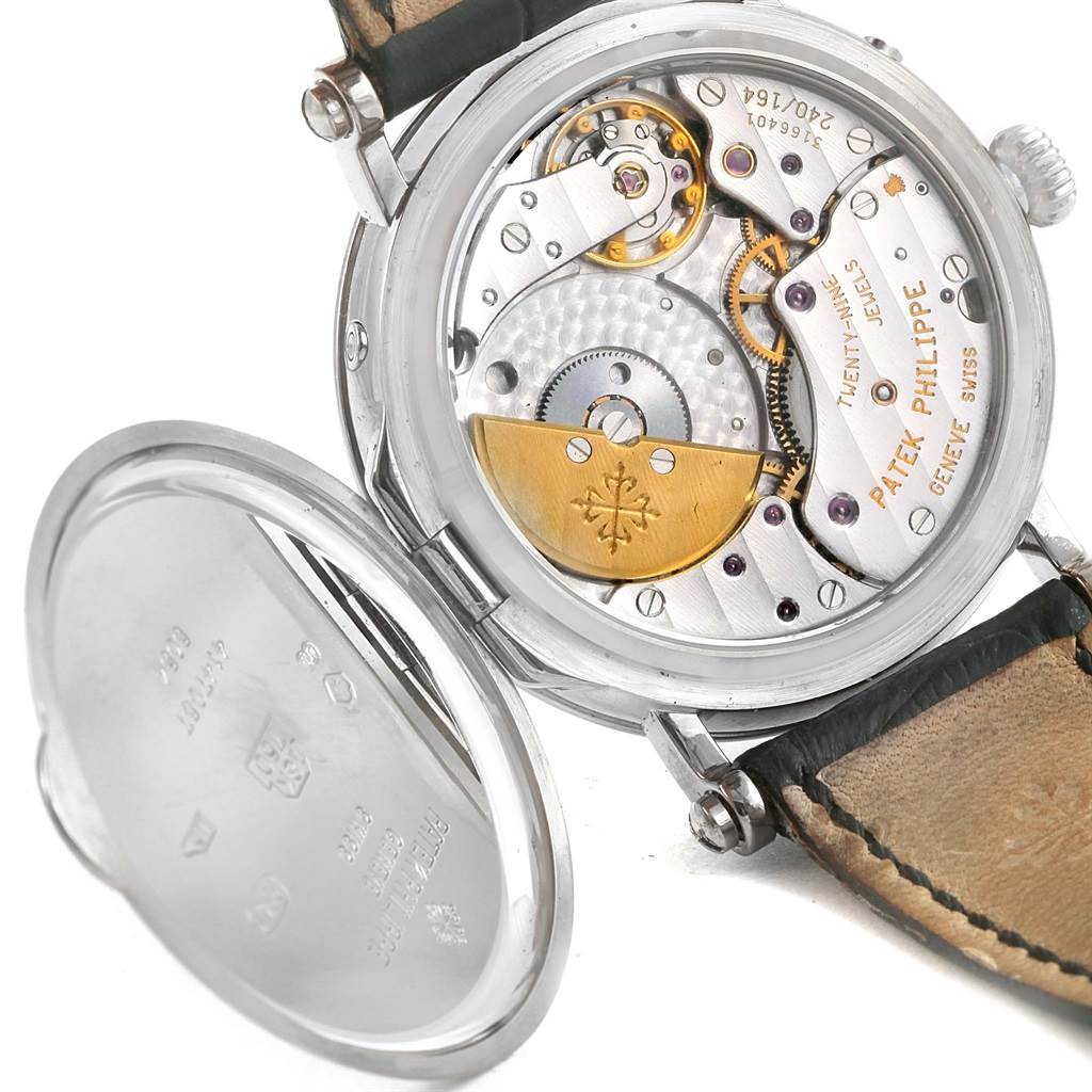 The image shows the back view of a Patek Philippe Complications 5054 Men's White Gold White Dial 5054 Men's White Gold White Dial model watch, highlighting its open case back and movement parts.