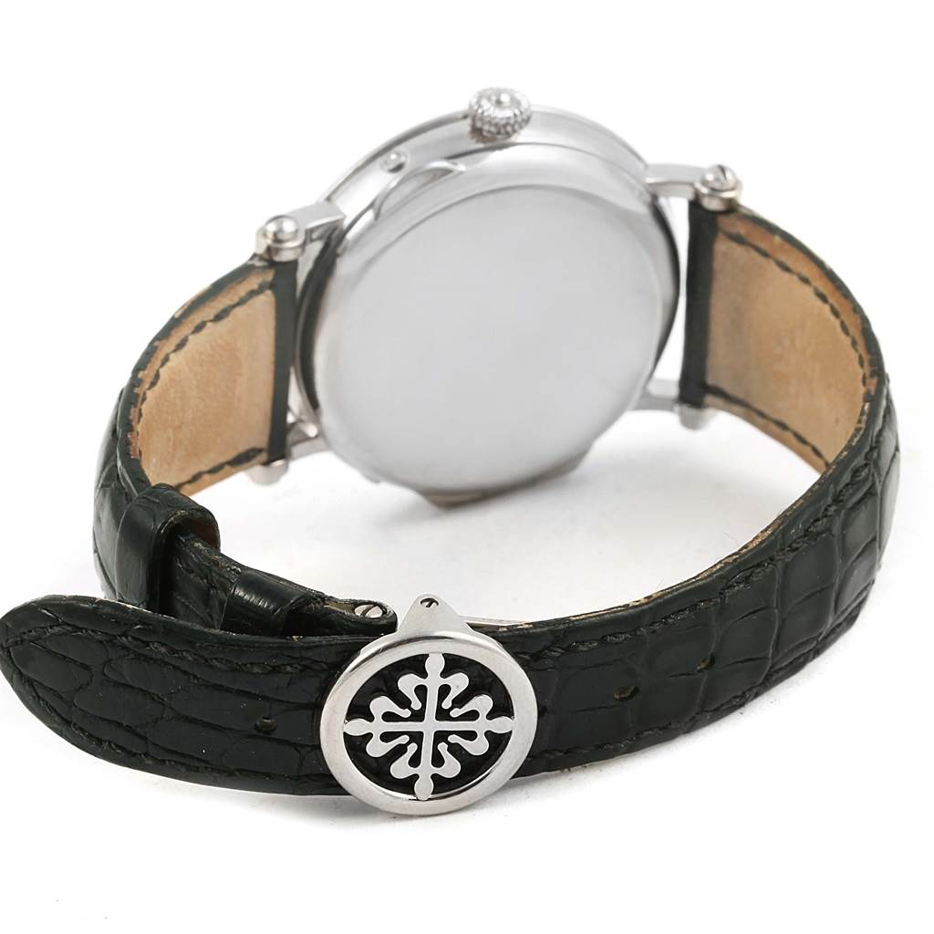 This image shows the back and side of the Patek Philippe Complications 5054 Men's White Gold White Dial 5054 Men's White Gold White Dial watch and its leather strap, highlighting the clasp.