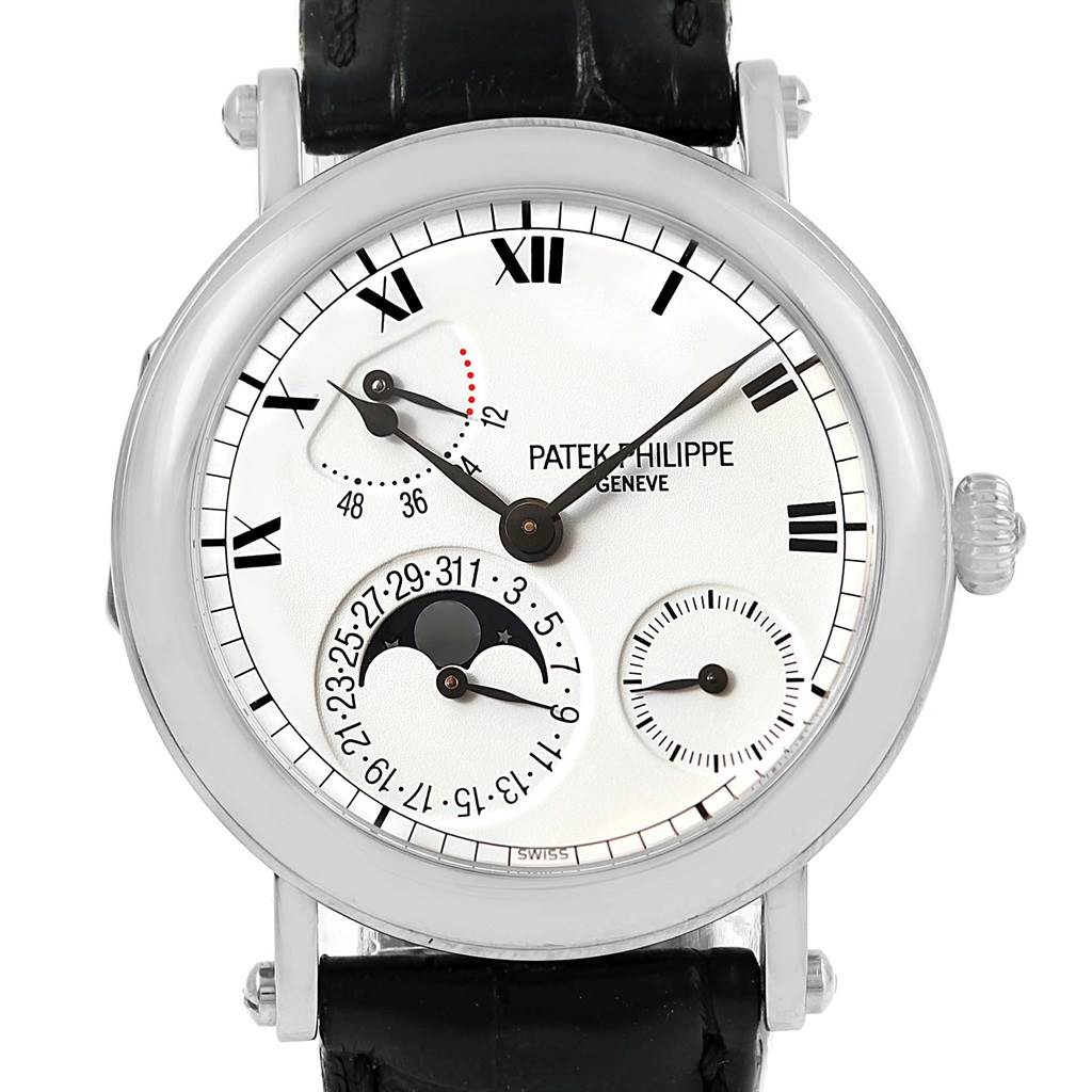 The Patek Philippe Complications 5054 Men's White Gold White Dial 5054 Men's White Gold White Dial model is shown from a front angle, displaying its face, sub-dials, and black leather strap.