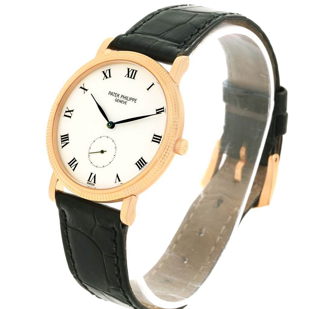 This image shows a Patek Philippe Calatrava 3919 Men's Rose Gold White Dial 3919 Men's Rose Gold White Dial watch from an angled top-down view, highlighting the face, case, and strap.