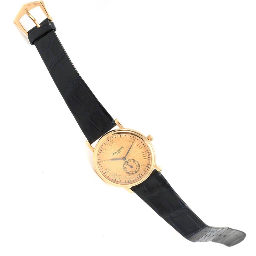 The image shows a Patek Philippe 5022 Yellow Gold Champagne Dial 5022 Yellow Gold Champagne Dial Calatrava Officier Yellow Gold Manual Wind Watch 5022, angled to display the face, strap, and buckle.