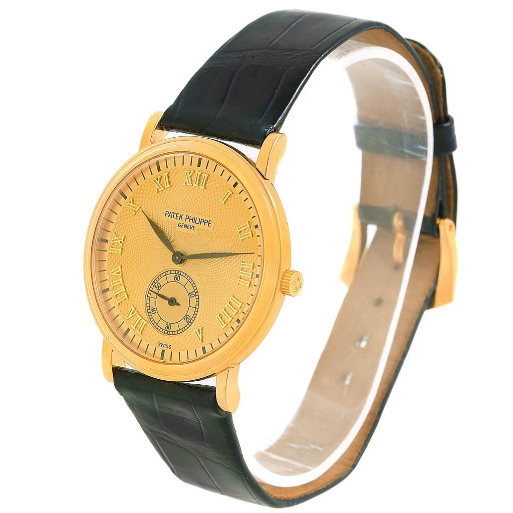 The Patek Philippe 5022 Yellow Gold Champagne Dial 5022 Yellow Gold Champagne Dial Calatrava Officier 5022 watch is shown at a front angle, displaying its yellow gold case, dial, and black leather strap.