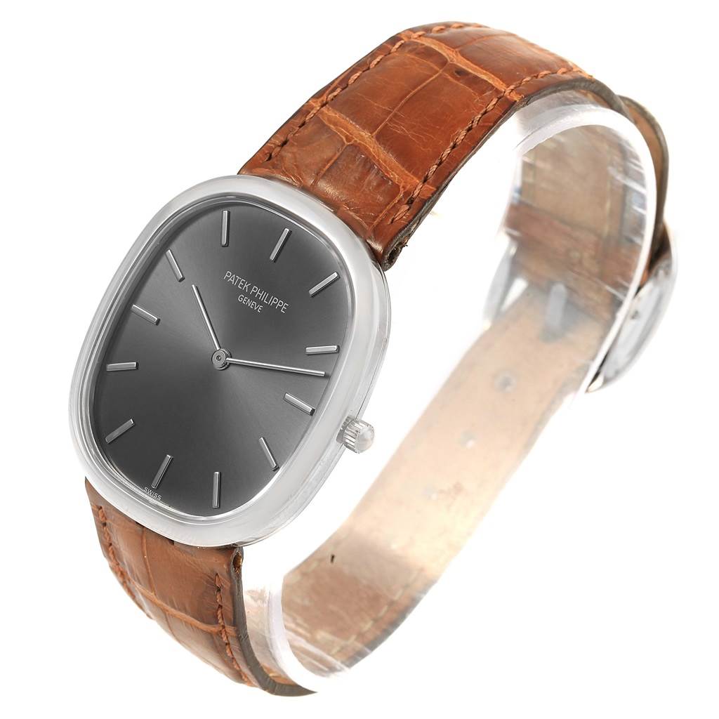 The image shows a Patek Philippe Golden Ellipse 3738 Men's White Gold Grey Dial 3738 Men's White Gold Grey Dial watch at a slight angle, displaying its oval face, crown, and brown leather strap.