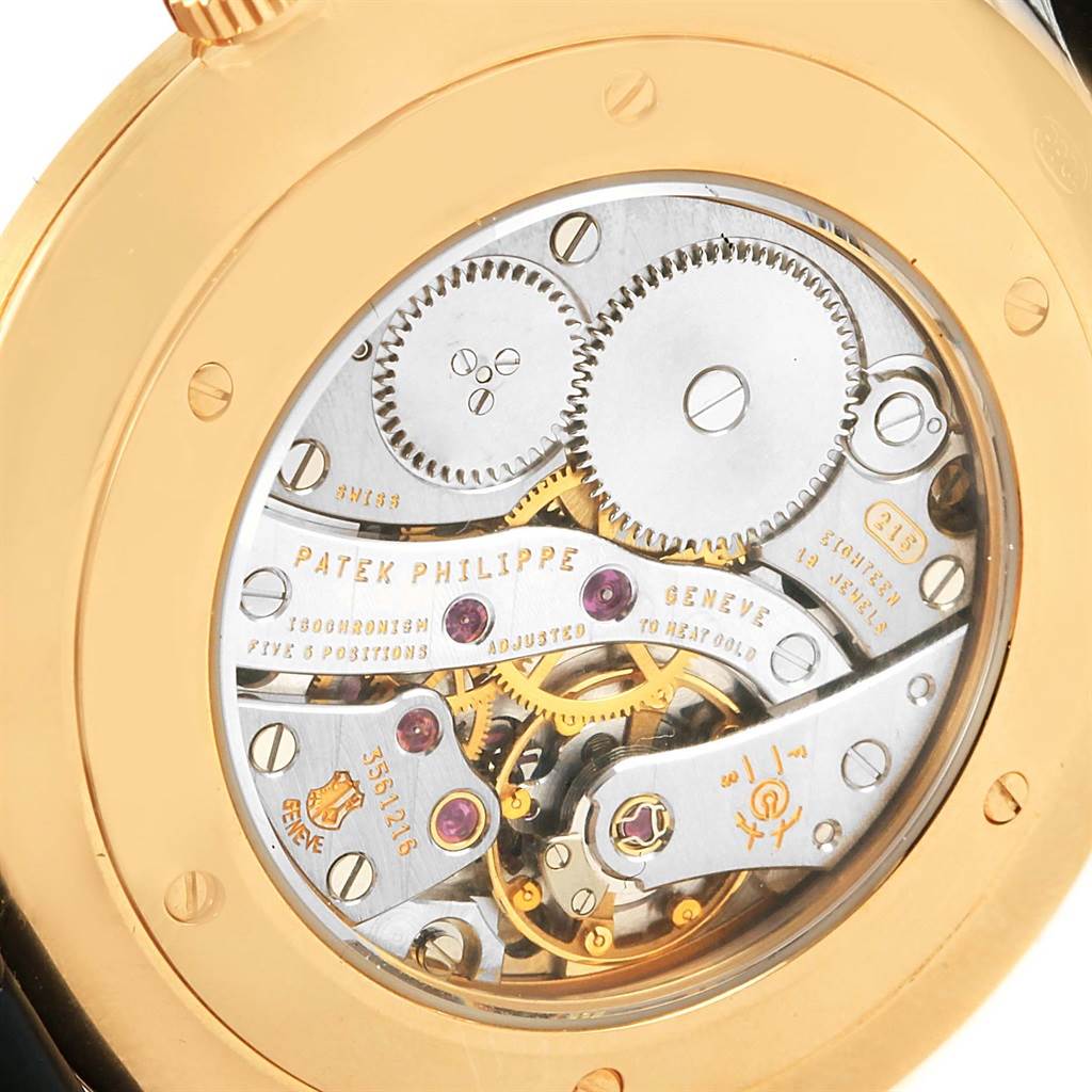 This image shows the intricate movement mechanism of a Patek Philippe Calatrava 5119J Men's Yellow Gold White Dial 5119J Men's Yellow Gold White Dial watch from the case-back view.