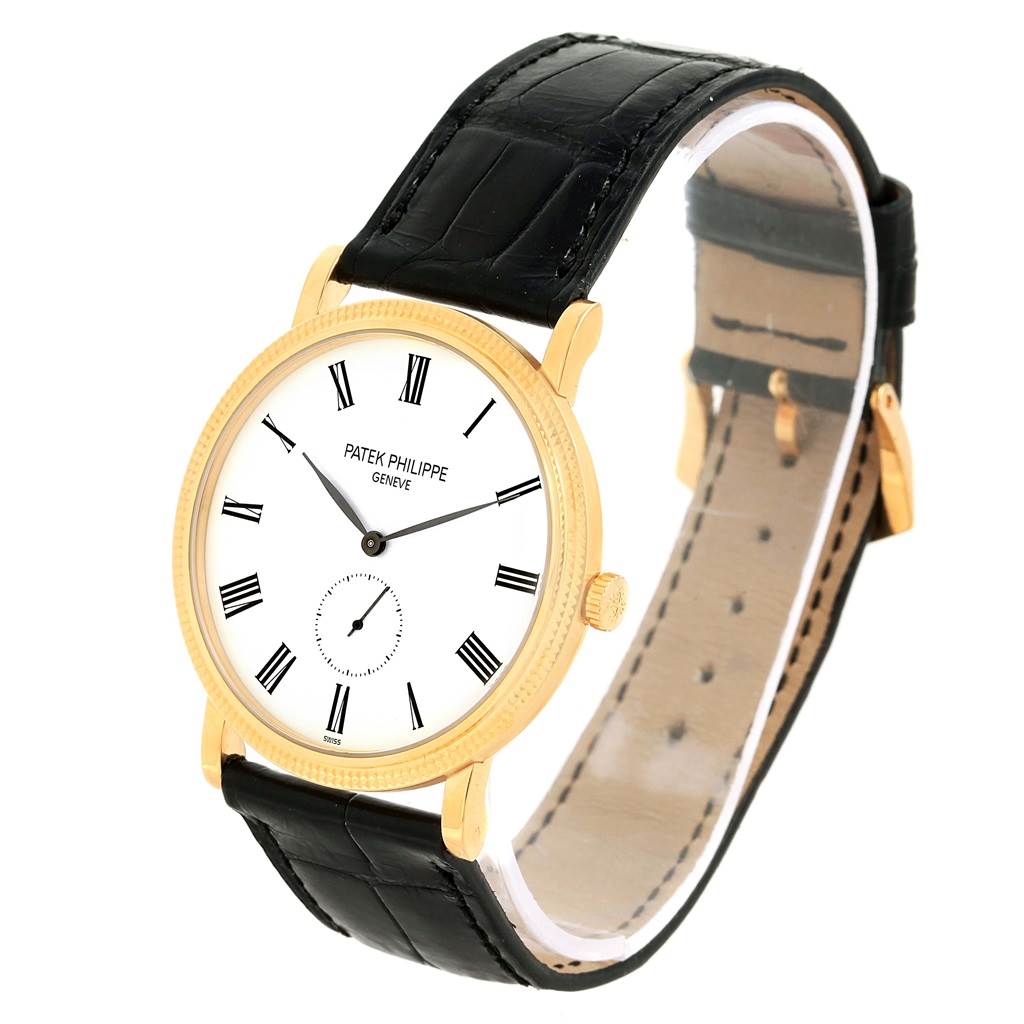 The image shows a Patek Philippe Calatrava 5119J Men's Yellow Gold White Dial 5119J Men's Yellow Gold White Dial watch from a three-quarter angle, highlighting its dial, case, crown, and leather strap.