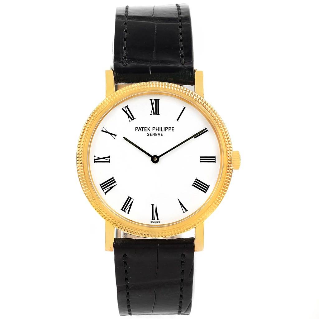 The image shows a frontal view of a Patek Philippe Calatrava 5120J Men's Yellow Gold White Dial 5120J Men's Yellow Gold White Dial watch with a gold case, white dial, and black leather strap.
