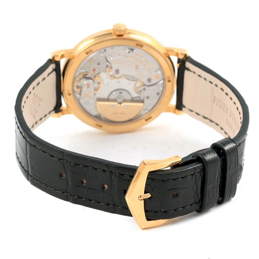 The image shows a rear view of the Patek Philippe Calatrava 5120J Men's Yellow Gold White Dial 5120J Men's Yellow Gold White Dial watch, highlighting its case back and black leather strap.