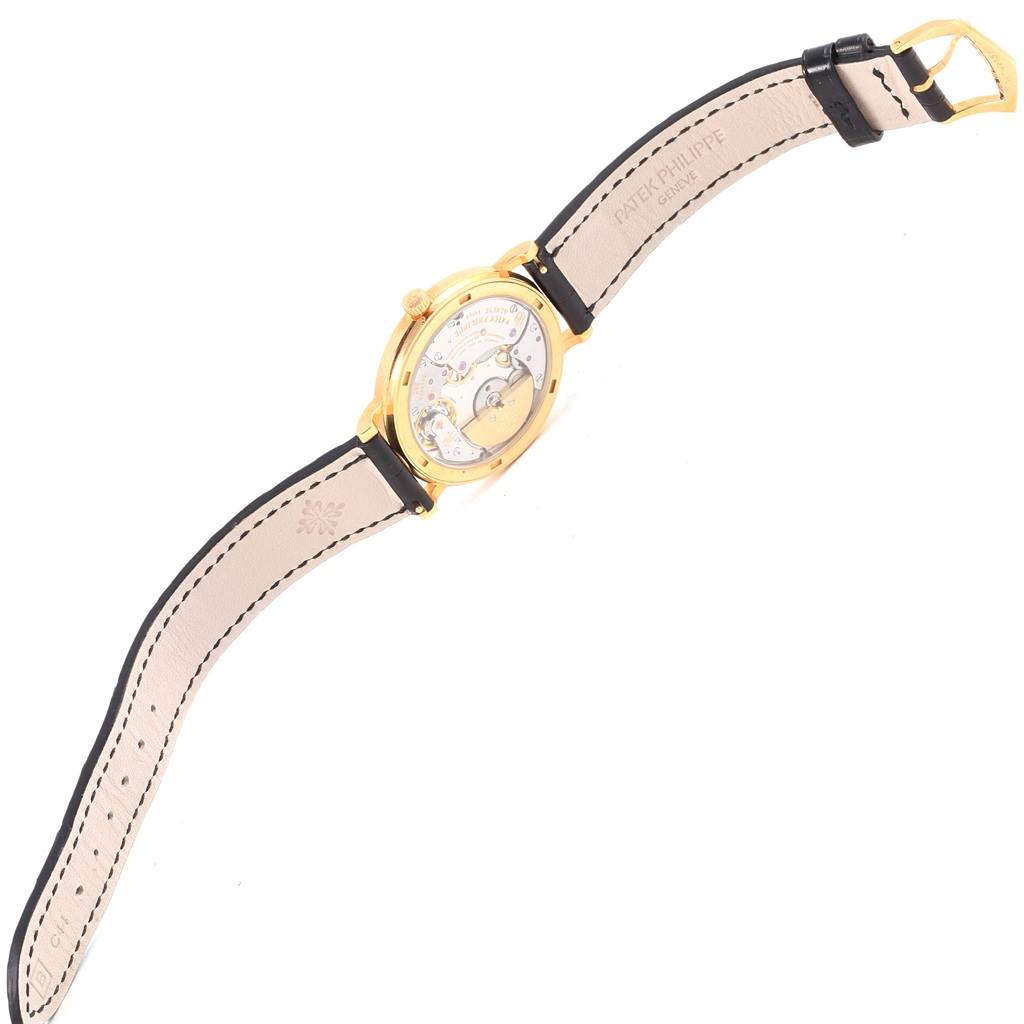 The image shows the back of the Patek Philippe Calatrava 5120J Men's Yellow Gold White Dial 5120J Men's Yellow Gold White Dial watch, revealing its movement, only the watch face is not shown.