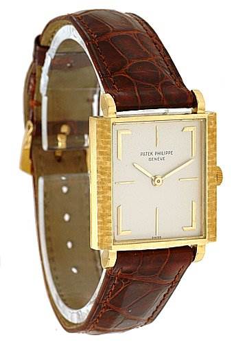 The image shows a Vintage Patek Philippe watch at a slight side angle, displaying its square dial, gold case, and brown leather strap.