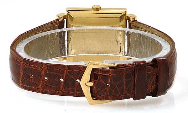 The image shows the back view of a Vintage Patek Philippe watch, highlighting its brown leather strap and gold clasp.