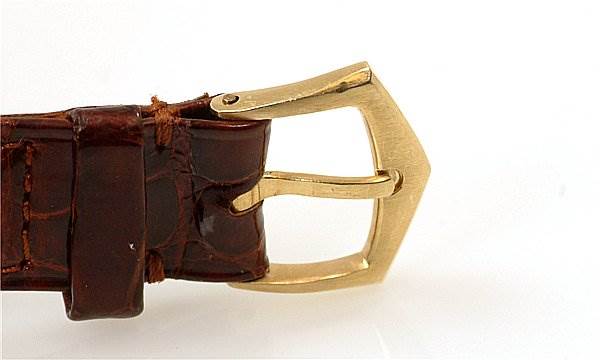 This image shows a close-up side view of the buckle and a portion of the leather strap of a Vintage Patek Philippe watch.