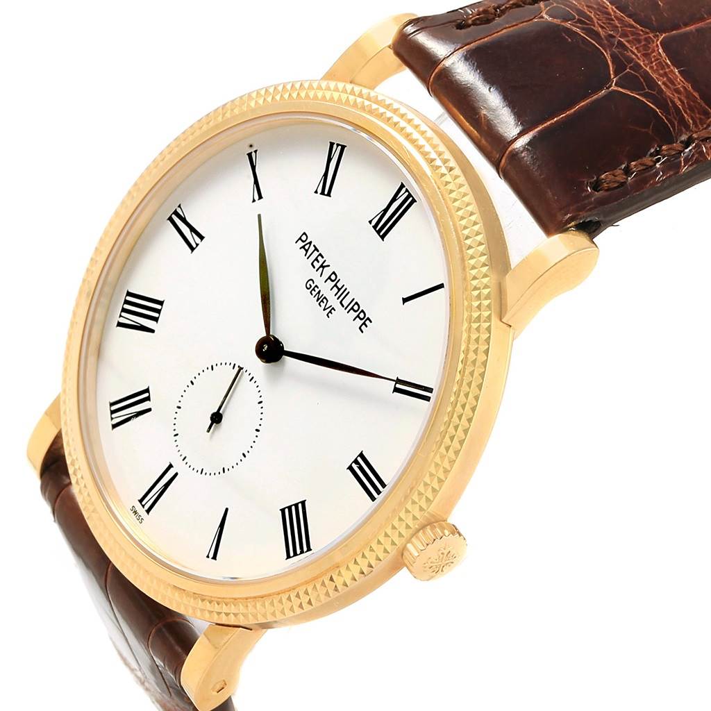 The Patek Philippe Calatrava 5119J Men's Yellow Gold White Dial 5119J Men's Yellow Gold White Dial watch is shown at a slight angle highlighting the face, bezel, crown, and strap.