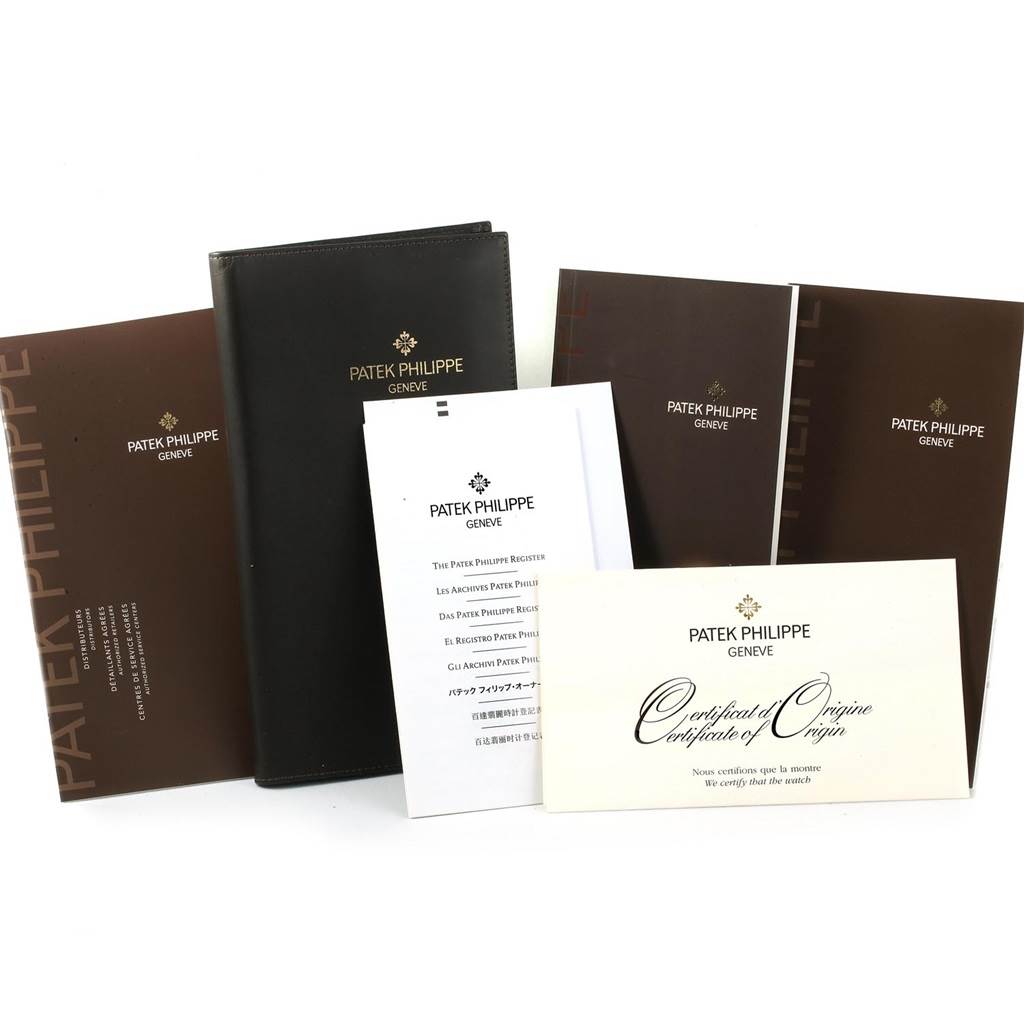 The image shows the documentation and certificates for a Patek Philippe Calatrava 5119J Men's Yellow Gold White Dial 5119J Men's Yellow Gold White Dial watch.