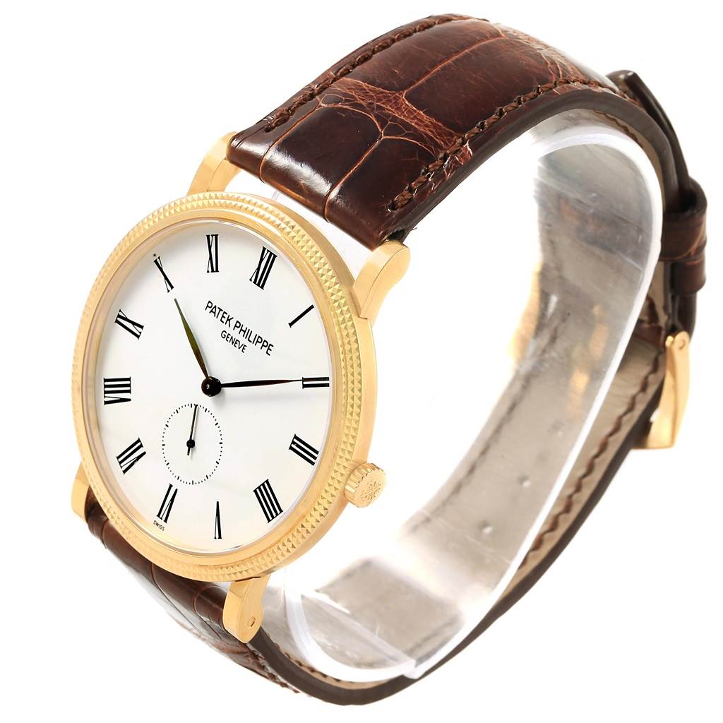 The image shows a Patek Philippe Calatrava 5119J Men's Yellow Gold White Dial 5119J Men's Yellow Gold White Dial watch at a three-quarter angle, highlighting the dial, crown, and leather strap.