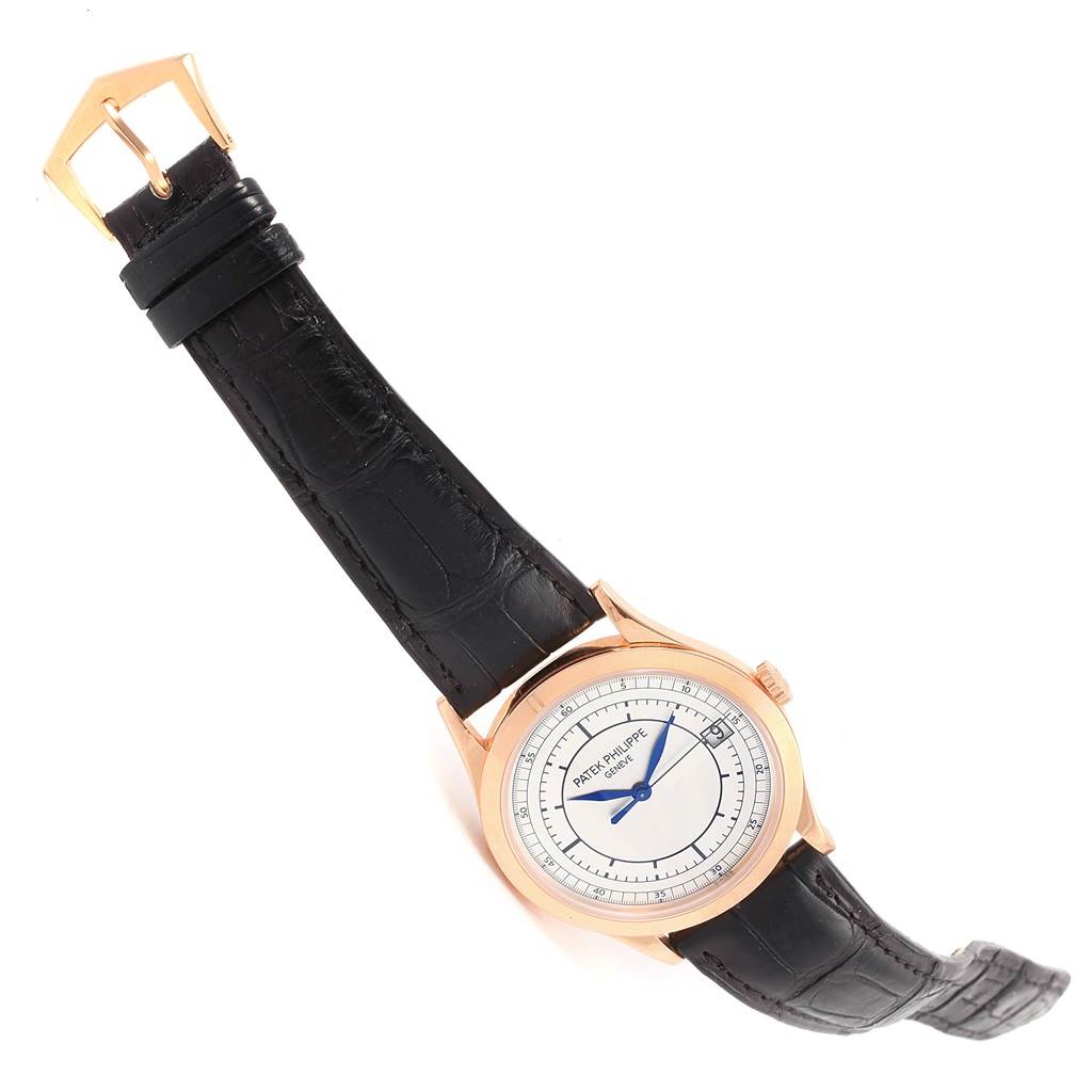 The image shows a Patek Philippe Calatrava 5296R-001 Men
s Rose Gold Silver Dial 5296R-001 Men
s Rose Gold Silver Dial watch at an angled view, displaying the face, bezel, and black leather strap.