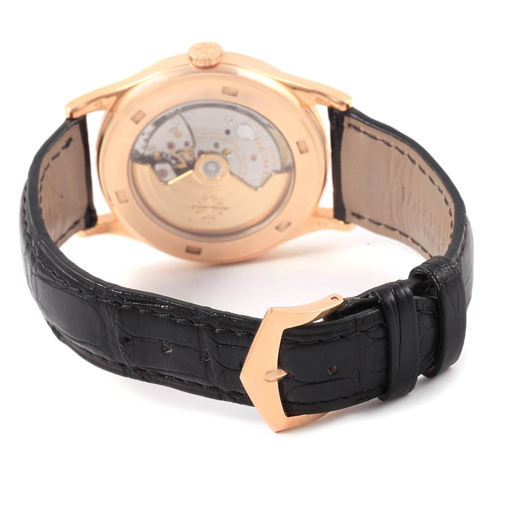 The image shows the rear view of a Patek Philippe Calatrava 5296R-001 Men
s Rose Gold Silver Dial 5296R-001 Men
s Rose Gold Silver Dial watch, highlighting its movement and black leather strap.