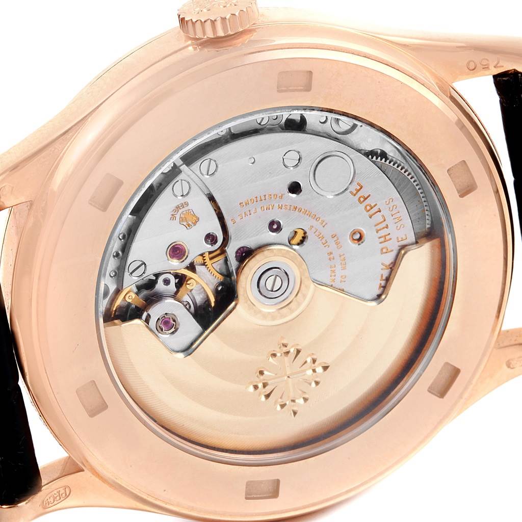 The image shows the back of the Patek Philippe Calatrava 5296R-001 Men
s Rose Gold Silver Dial 5296R-001 Men
s Rose Gold Silver Dial watch, highlighting its intricate movement.