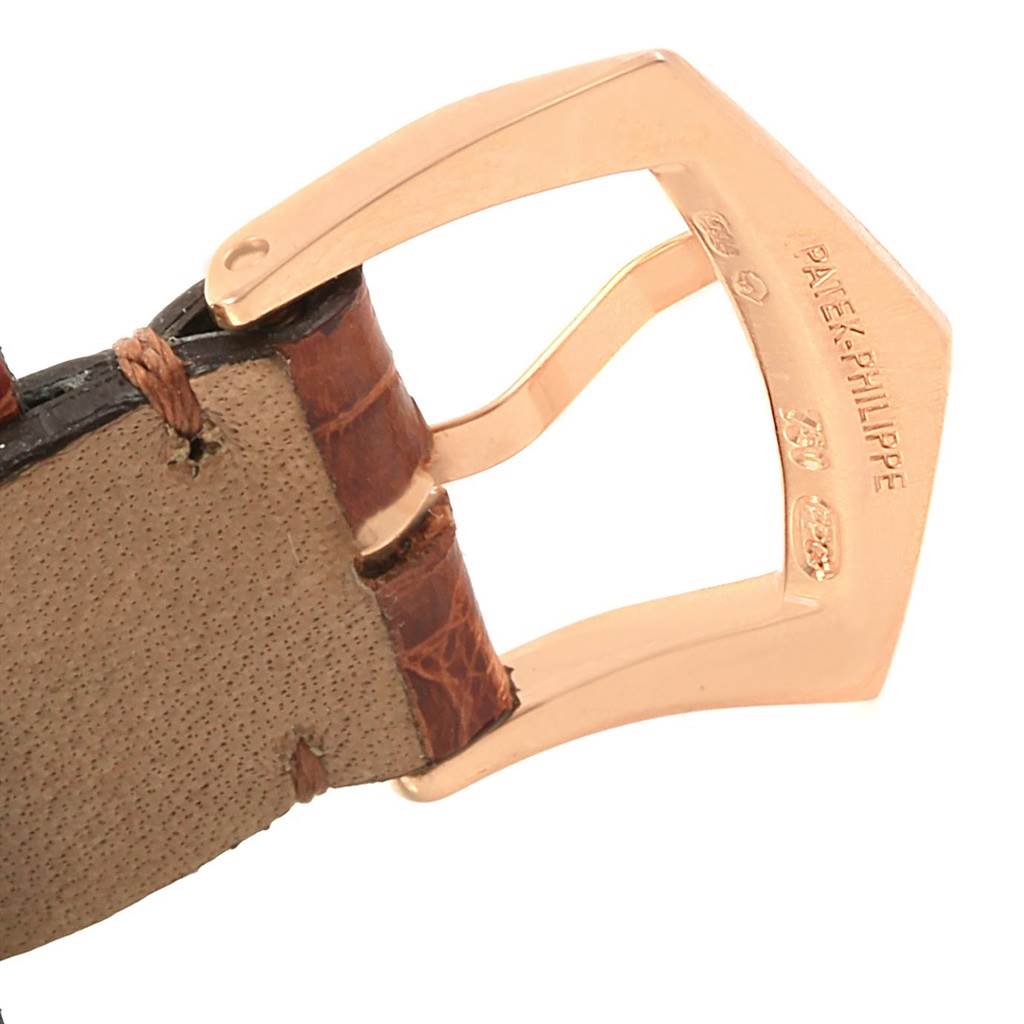 This image shows a close-up of the buckle and part of the leather strap of a Patek Philippe Gondolo 5010R Men's Rose Gold Silver Dial 5010R Men's Rose Gold Silver Dial watch.