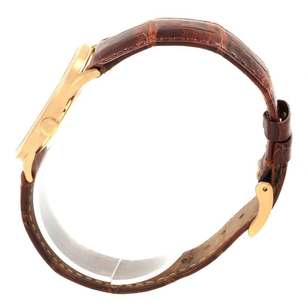 The image shows a side view of the Patek Philippe Golden Ellipse 3546 Men's Yellow Gold Champagne Dial 3546 Men's Yellow Gold Champagne Dial watch, highlighting its case, crown, and brown leather strap.