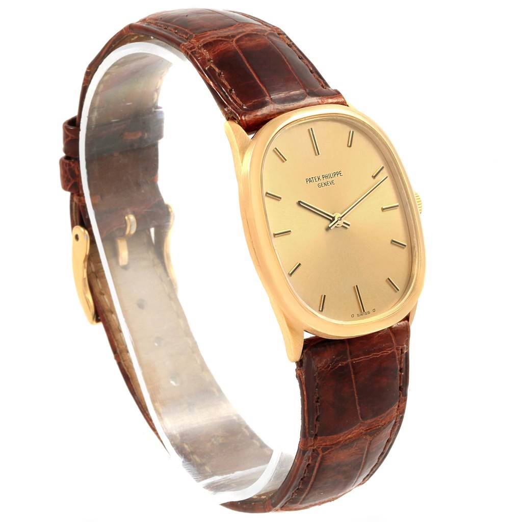 The Patek Philippe Golden Ellipse 3546 Men's Yellow Gold Champagne Dial 3546 Men's Yellow Gold Champagne Dial watch is shown at a slight angle, displaying the gold case, dial, and brown leather strap.