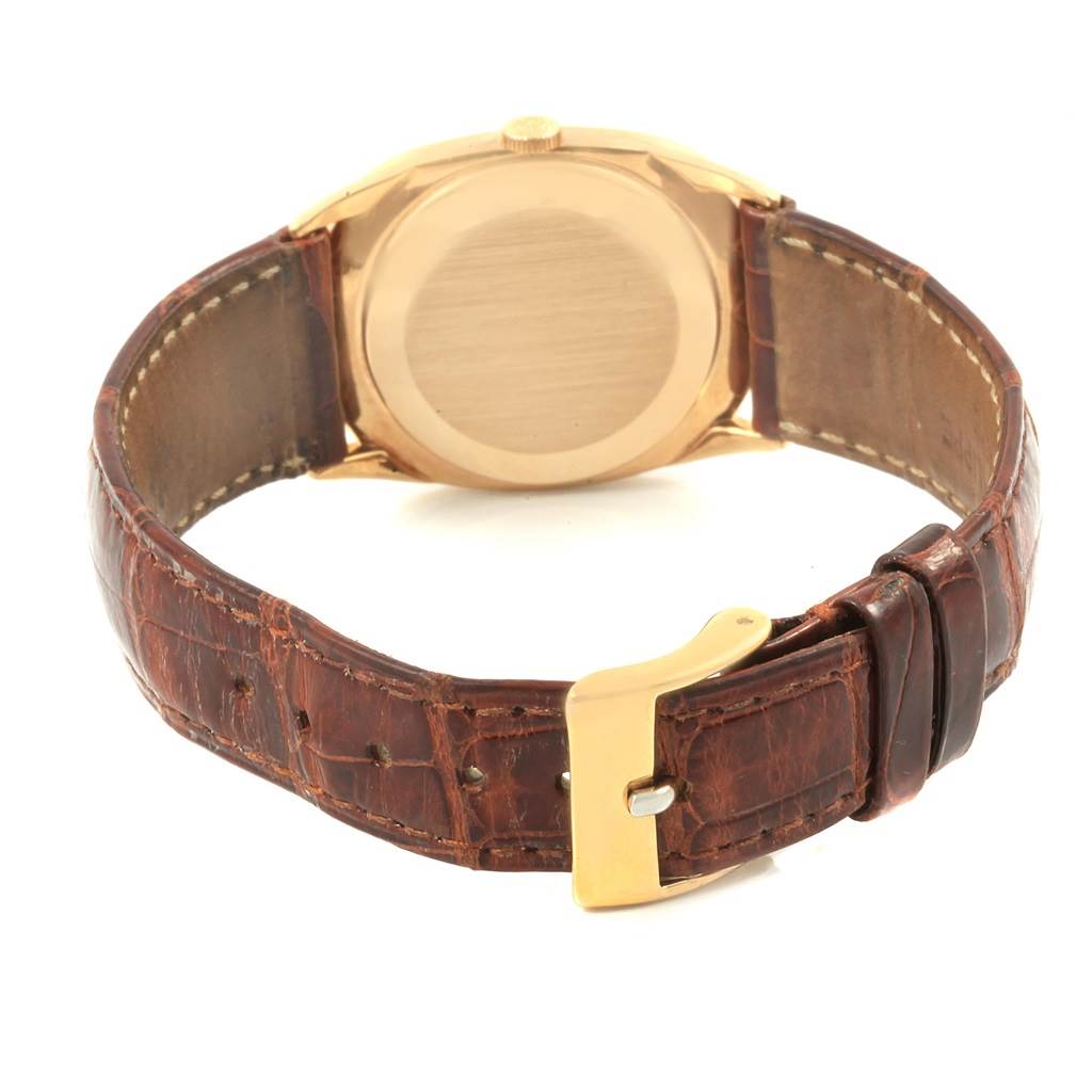 The image shows the back view of a Patek Philippe Golden Ellipse 3546 Men's Yellow Gold Champagne Dial 3546 Men's Yellow Gold Champagne Dial watch, including the leather strap and gold buckle.