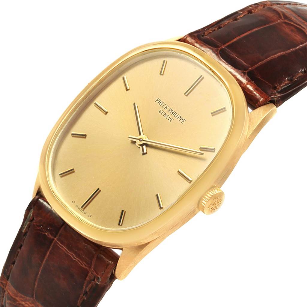 The image shows a top-side view of a Patek Philippe Golden Ellipse 3546 Men's Yellow Gold Champagne Dial 3546 Men's Yellow Gold Champagne Dial watch, highlighting its gold case, dial, and brown leather strap.