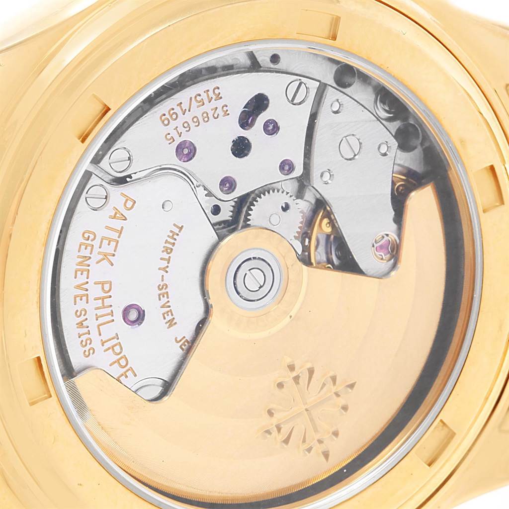 The image shows the back view of the Patek Philippe 5036 Men's Yellow Gold White Dial 5036 Men's Yellow Gold White Dial Annual Calendar Moonphase Yellow Gold Watch 5036, highlighting its movement and intricate mechanics.