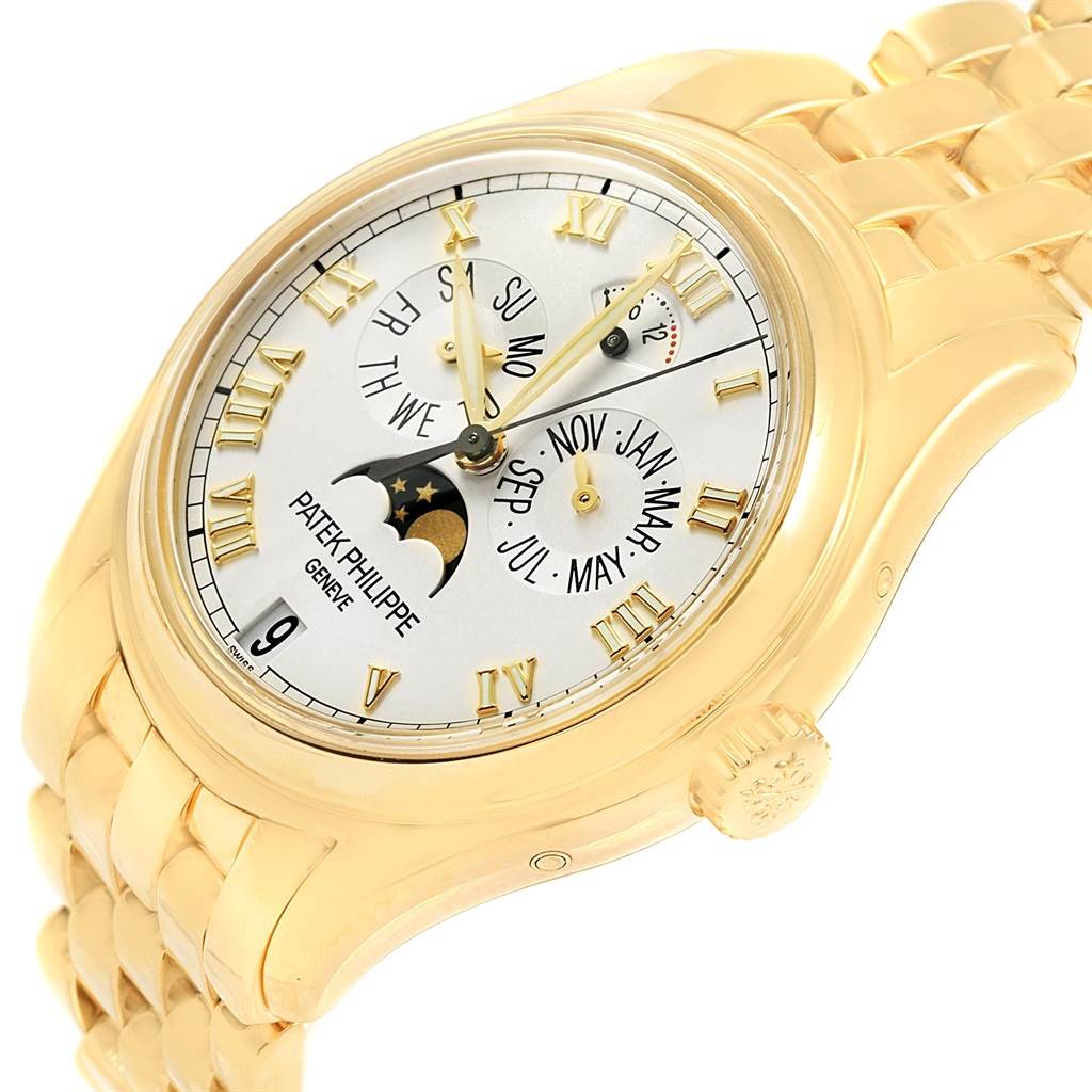 The image shows a Patek Philippe 5036 Men's Yellow Gold White Dial 5036 Men's Yellow Gold White Dial Annual Calendar Moonphase Yellow Gold Watch 5036 at an angled close-up highlighting its dial and bracelet.
