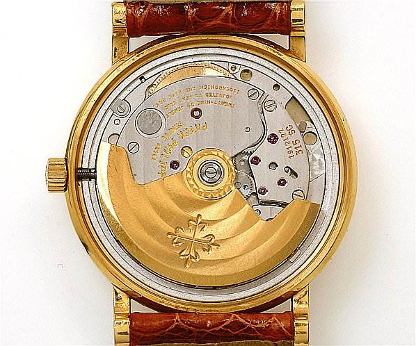 The image shows the caseback of a Patek Philippe Calatrava 3802/200 Men's Yellow Gold White Dial 3802/200 Men's Yellow Gold White Dial watch, revealing its movement and rotor.