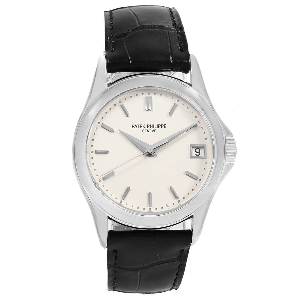The Patek Philippe Calatrava 5127G Men's White Gold White Dial 5127G Men's White Gold White Dial watch is shown from a front angle, displaying the dial, hands, crown, and black leather strap.