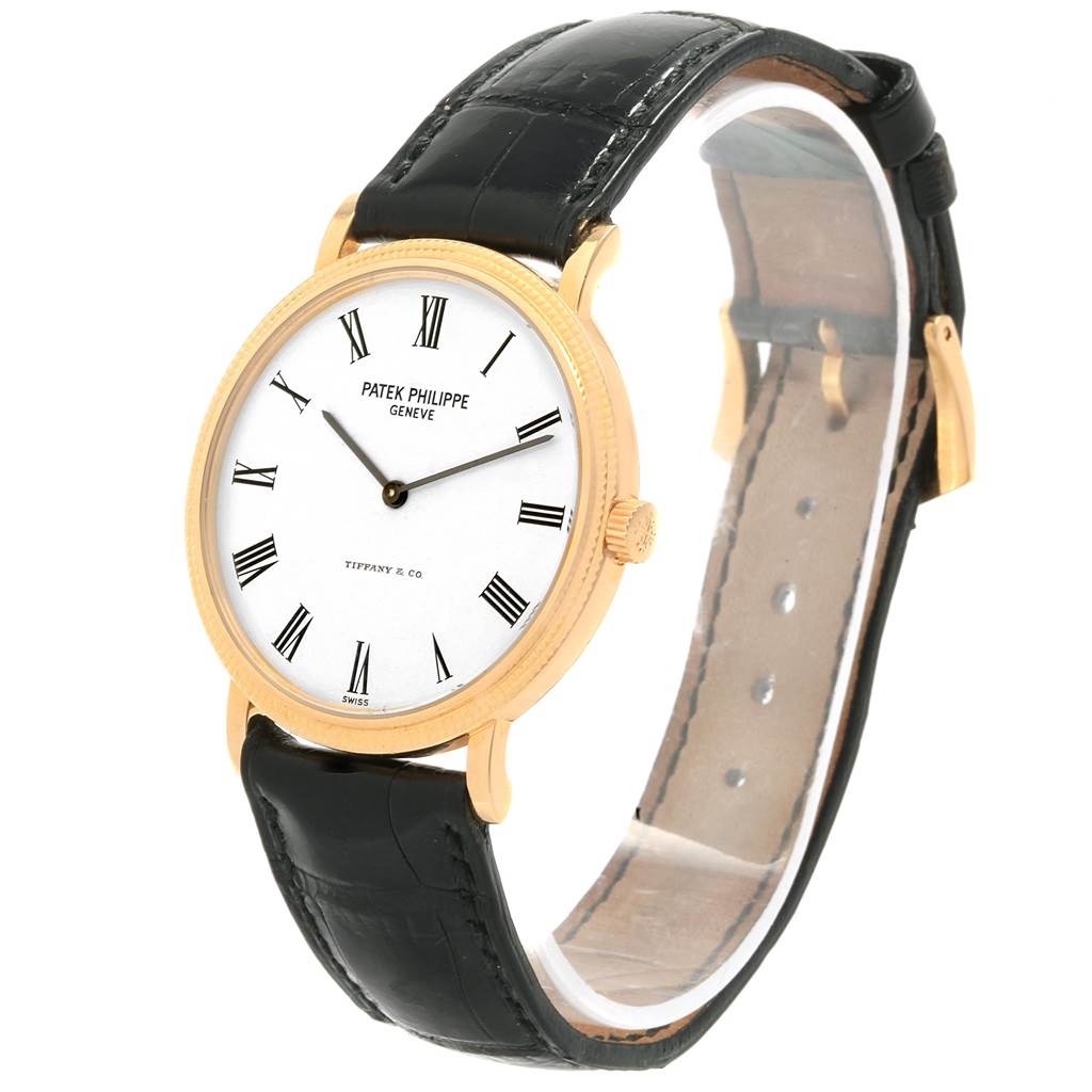 The image shows a Patek Philippe Calatrava 5120J Men's Yellow Gold White Dial 5120J Men's Yellow Gold White Dial watch from a front and slightly angled perspective, highlighting its face, strap, and clasp.