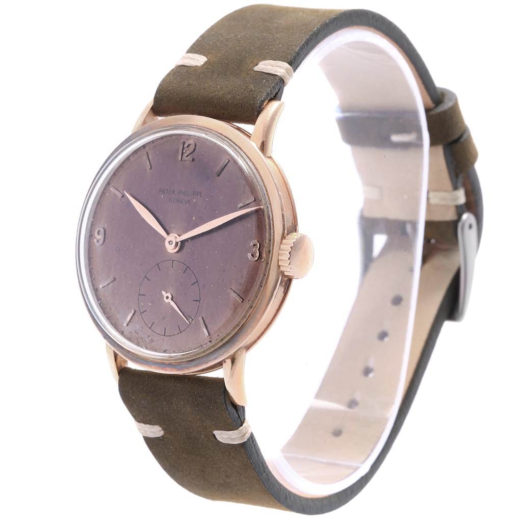 The image shows a Patek Philippe Vintage watch with a brown dial, Arabic numerals, and a leather strap, viewed from a front angle.