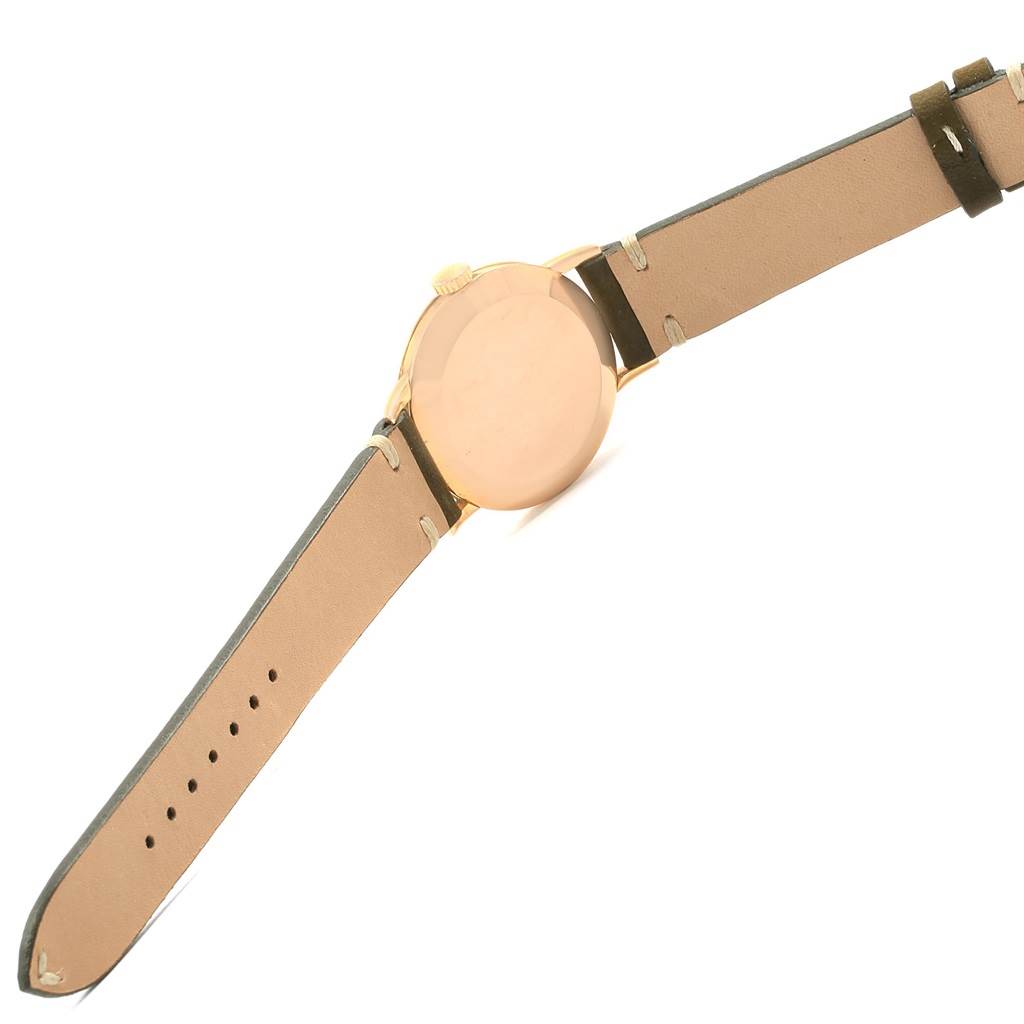 The image shows the back view of a Vintage Patek Philippe watch including its closed case and leather strap.