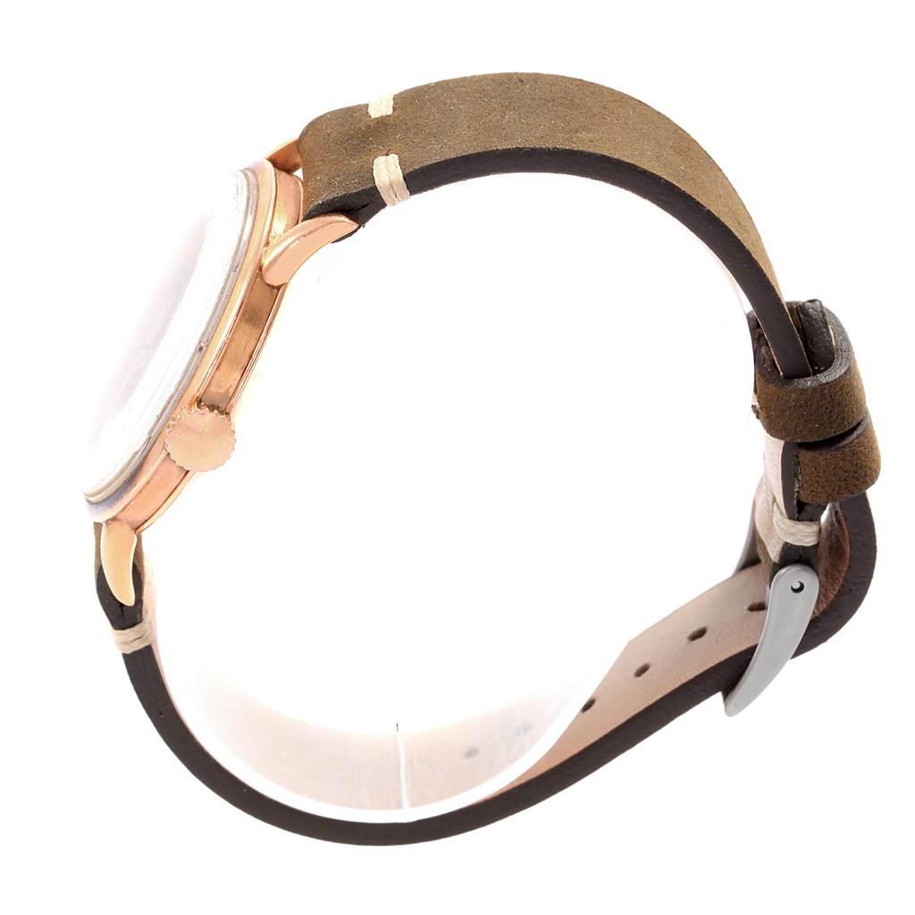 Side view of the Patek Philippe Vintage watch showing the crown, bezel, and leather strap.