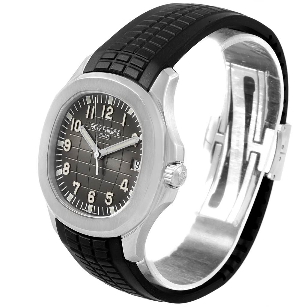 The Patek Philippe Aquanaut 5167A Men's Stainless Steel Black Dial 5167A Men's Stainless Steel Black Dial watch is shown at an angled side view, displaying the face, case, crown, and strap.