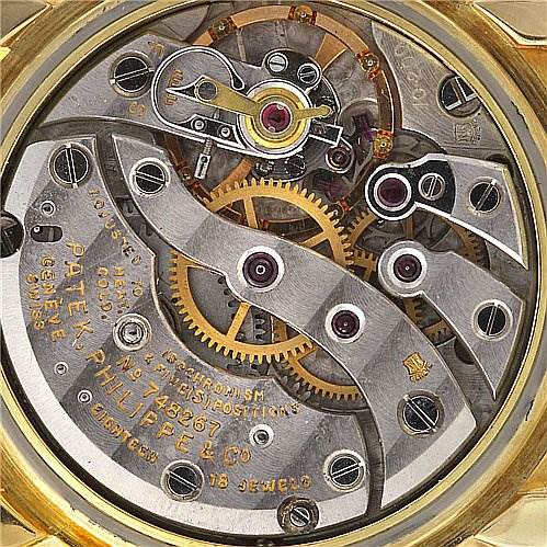 The image shows the intricate inner mechanisms of the movement in a vintage Patek Philippe watch.