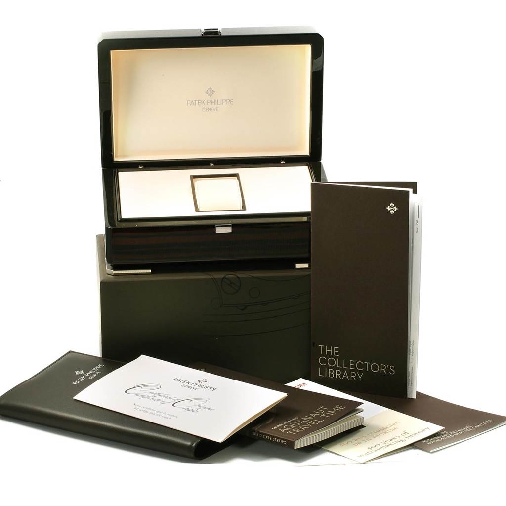 The image shows an open box with Patek Philippe branding, along with documents, likely for the Aquanaut model.
