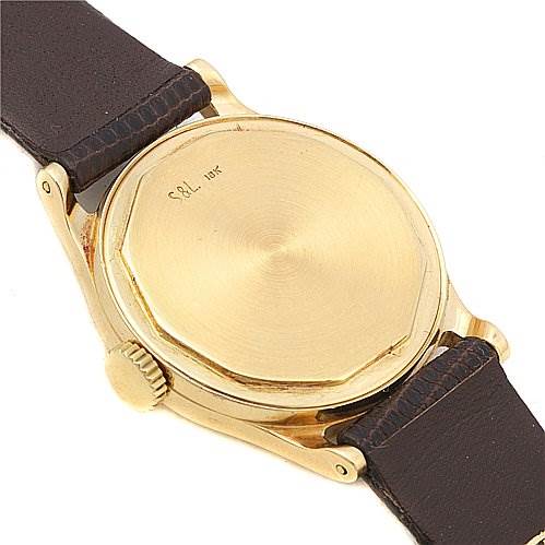 This image shows the back case, crown, and leather strap of a Vintage Patek Philippe watch.
