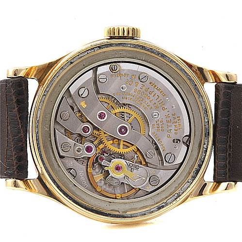 The image shows the back view of a Vintage Patek Philippe watch displaying its mechanical movement.