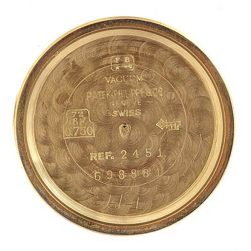 The image shows the inside back cover of a Vintage Patek Philippe watch, model reference 2451, with various engravings and hallmarks.